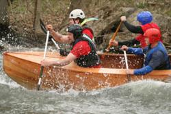 New Energy Works timberframers teamed up to battle the rapids in a custom crafted canoe during the Wild Water Derby. Photo © David Spier